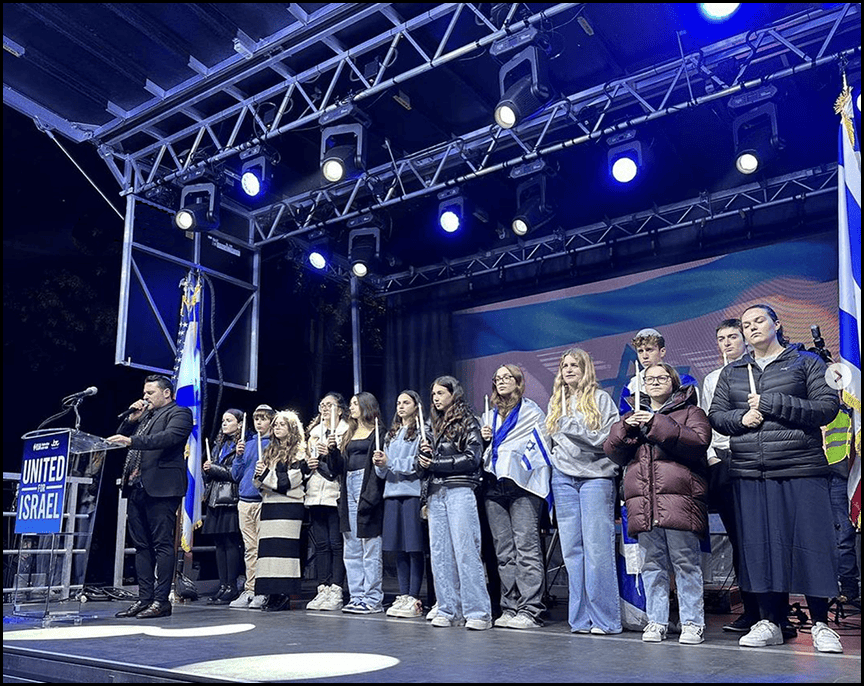 8th Grader Kaia representing Rodeph Sholom School on the podium at the United for Israel: Marking 30 Days rally on the UWS.